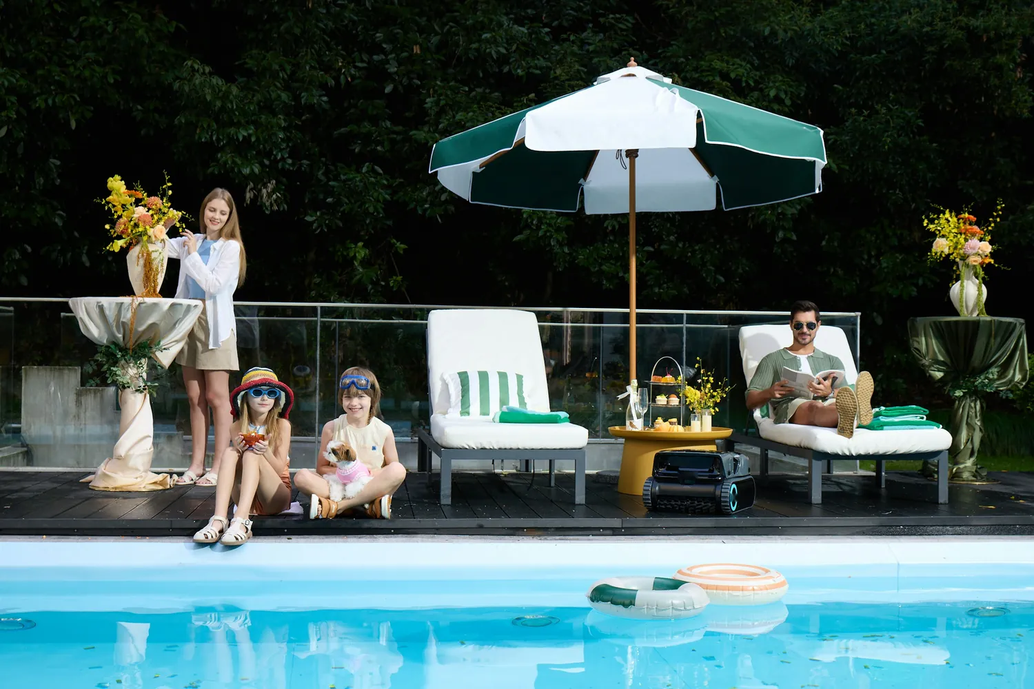 A family relaxing together by the pool on a sunny club terrace.